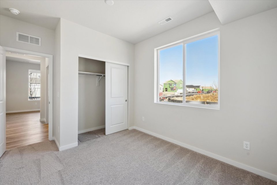 A room with white walls and a window.