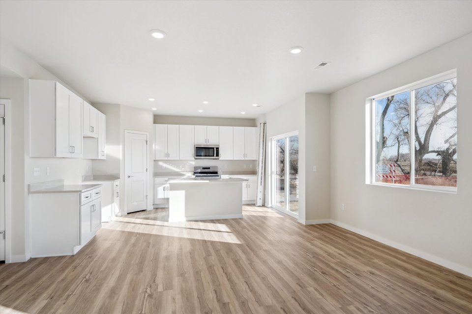 A kitchen with white cabinets.