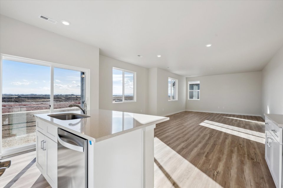 A kitchen with a large window.