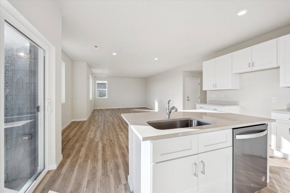 A kitchen with white cabinets.