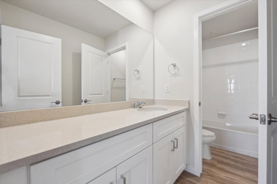 A bathroom with a large mirror.