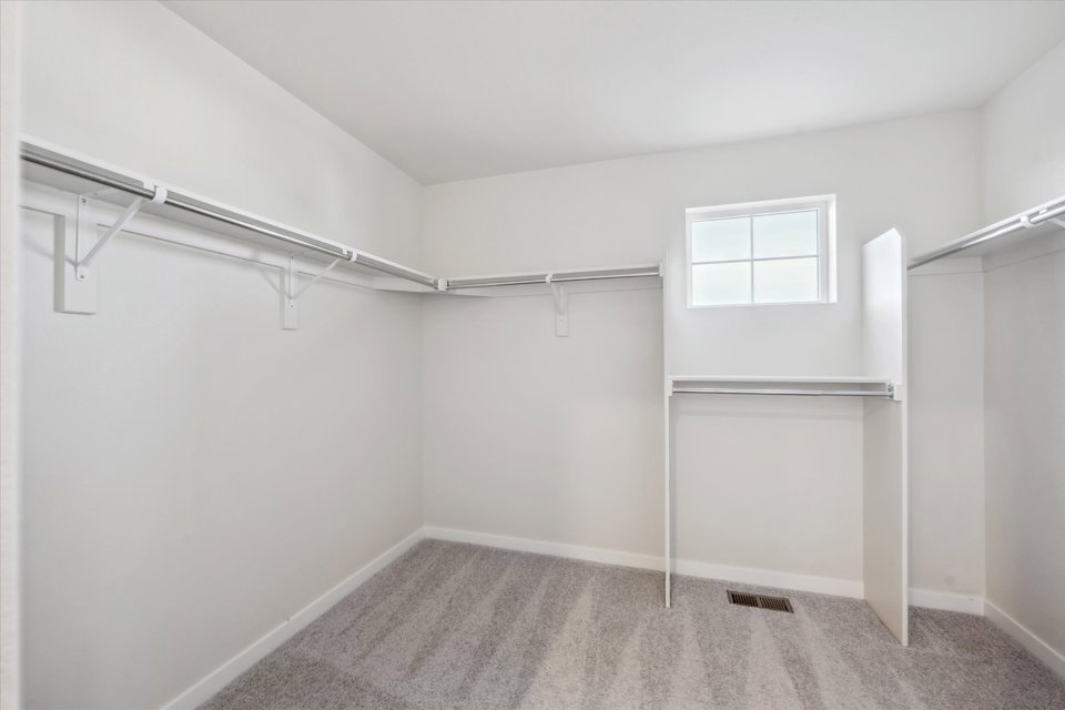 A room with a white wall and a window.
