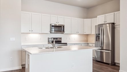 A kitchen with white cabinets.
