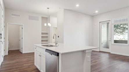 A kitchen with white cabinets.