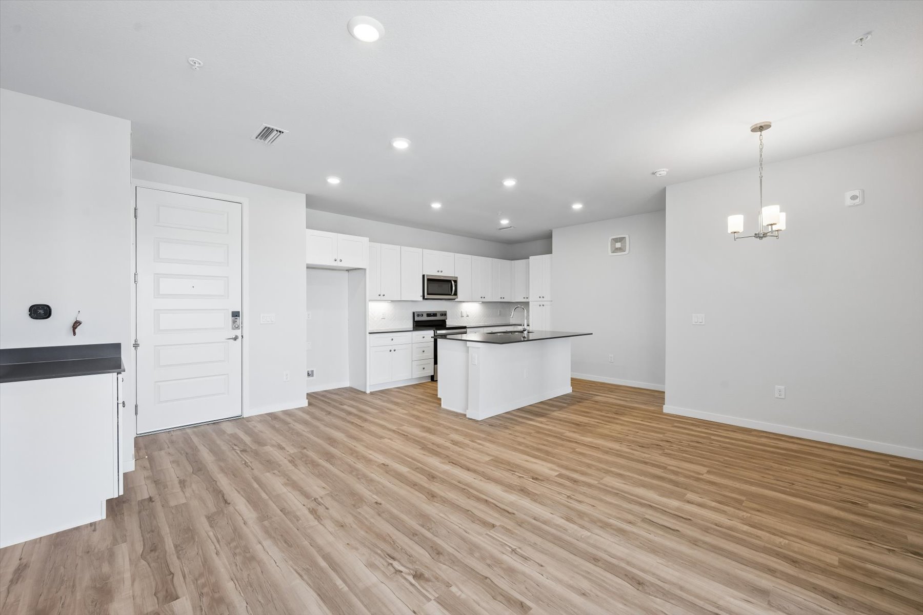 A large kitchen with white cabinets.