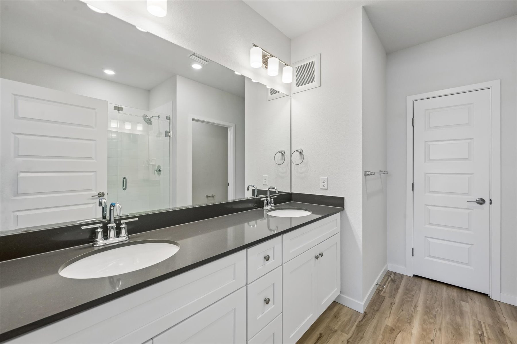 A bathroom with a large mirror.