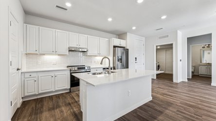 A kitchen with white cabinets.