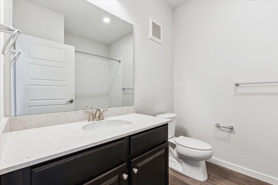 A bathroom with a sink toilet and shower.