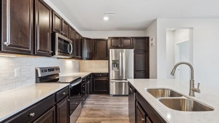 A kitchen with black cabinets.