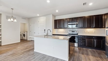 A kitchen with black cabinets.