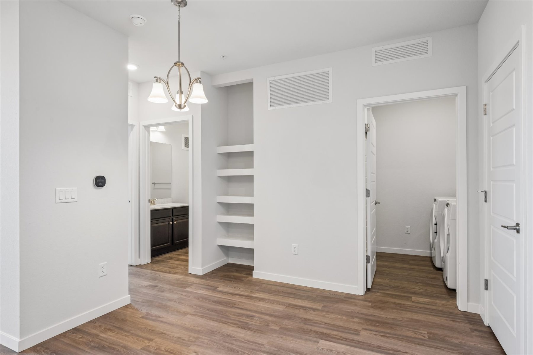 A room with white walls and a wood floor.