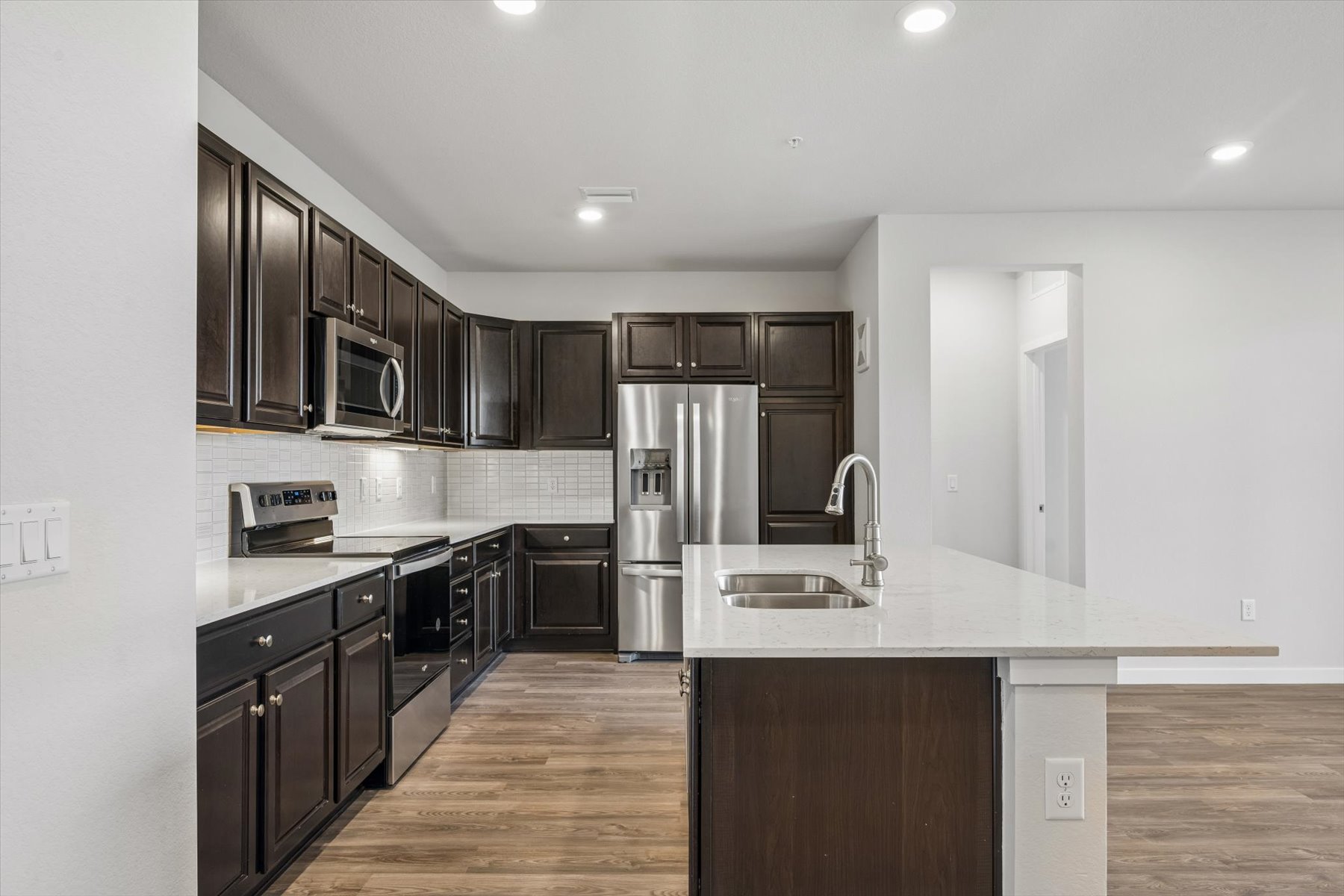 A kitchen with black cabinets.
