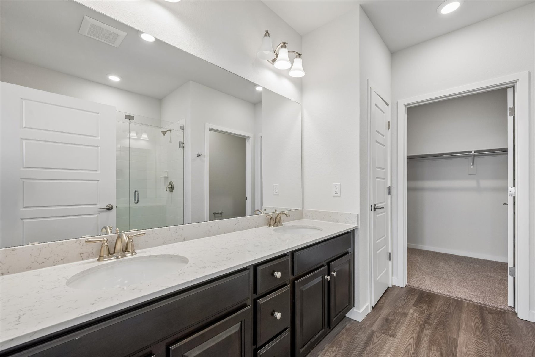 A bathroom with a large mirror.