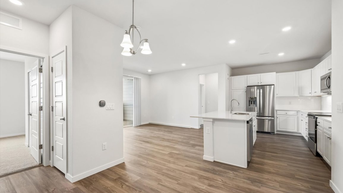 A kitchen with white cabinets.