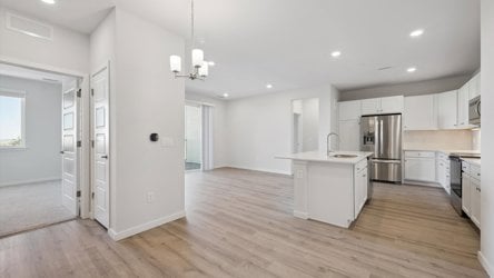A kitchen with white cabinets.