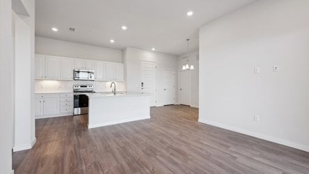 A kitchen with white cabinets.