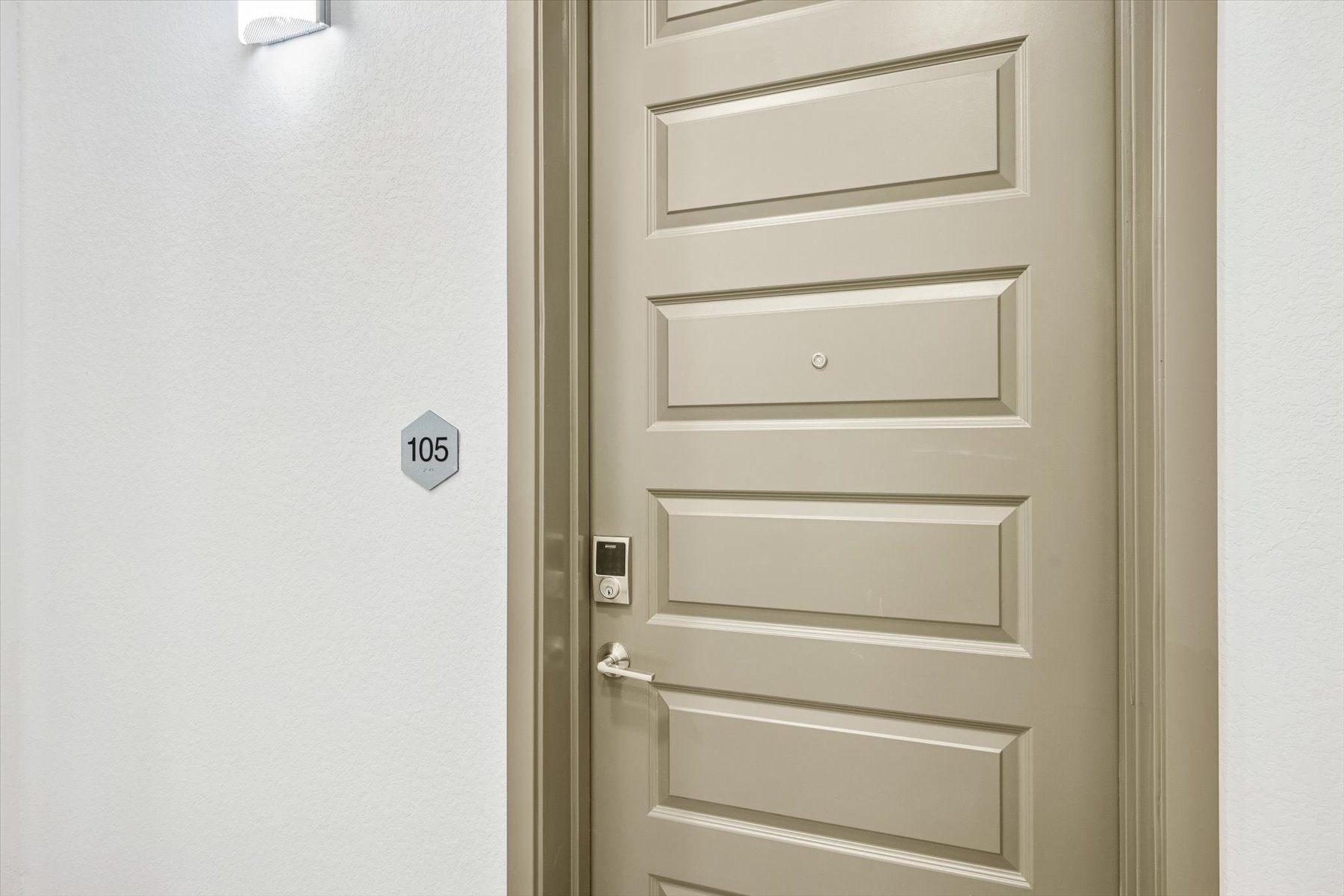 A white door with a light switch.