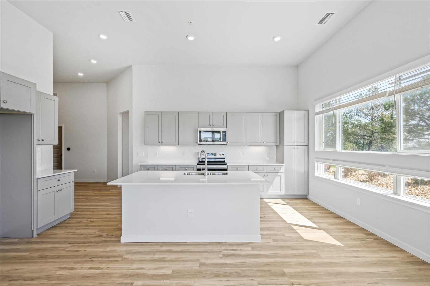 A kitchen with white cabinets.