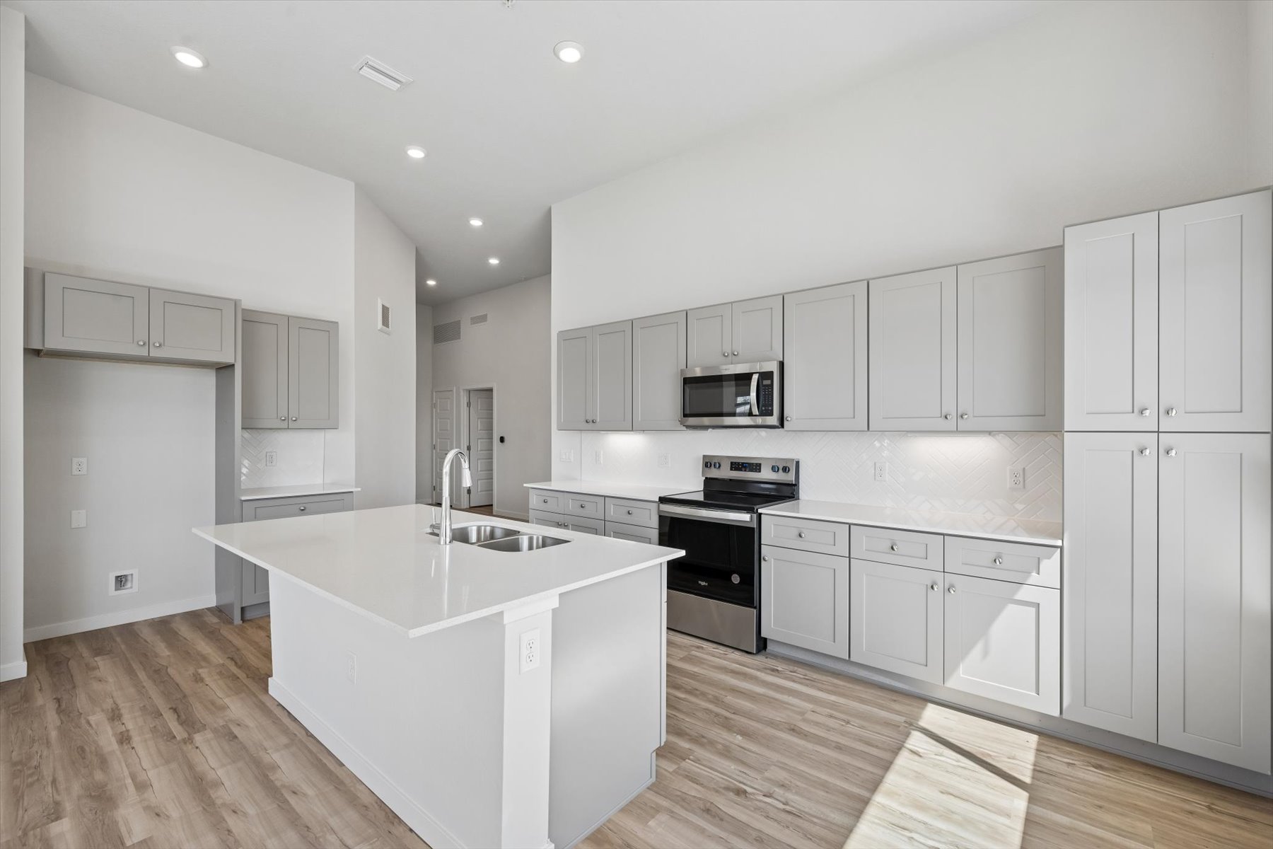 A kitchen with white cabinets.