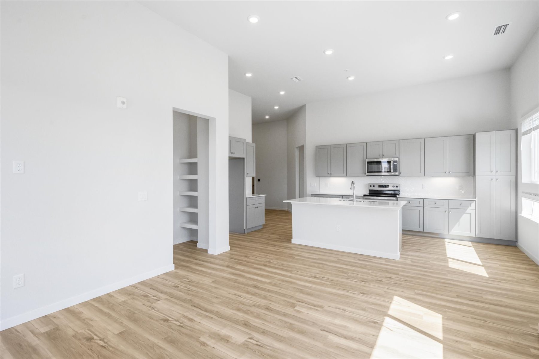 A kitchen with white cabinets.
