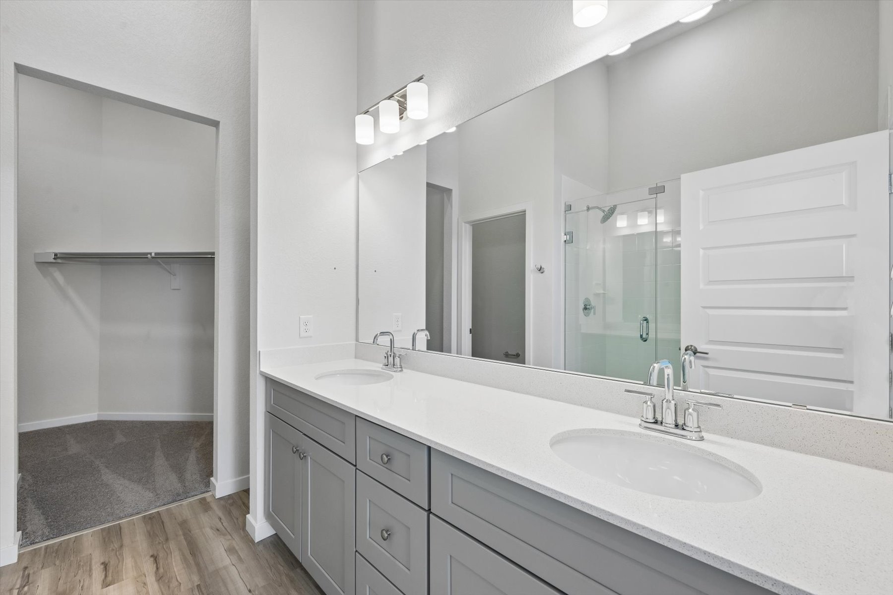 A bathroom with a large mirror.