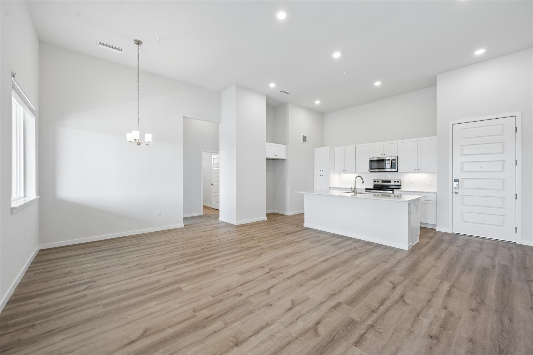 A large kitchen with white cabinets.