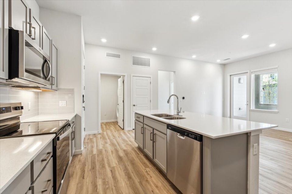 A kitchen with white cabinets.