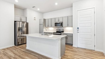 A kitchen with white cabinets.