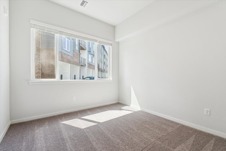A room with a window and a tile floor.