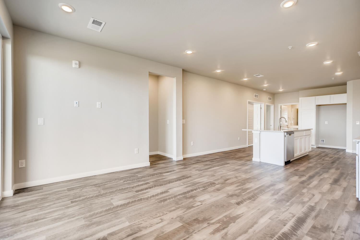 A room with white walls and wood floors.