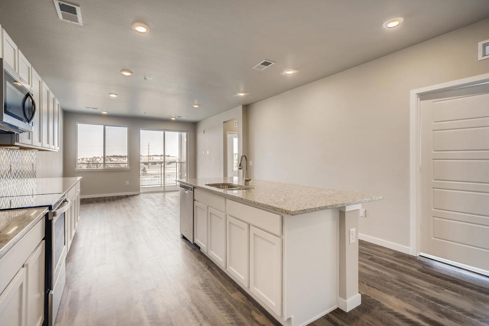 A kitchen with white cabinets.