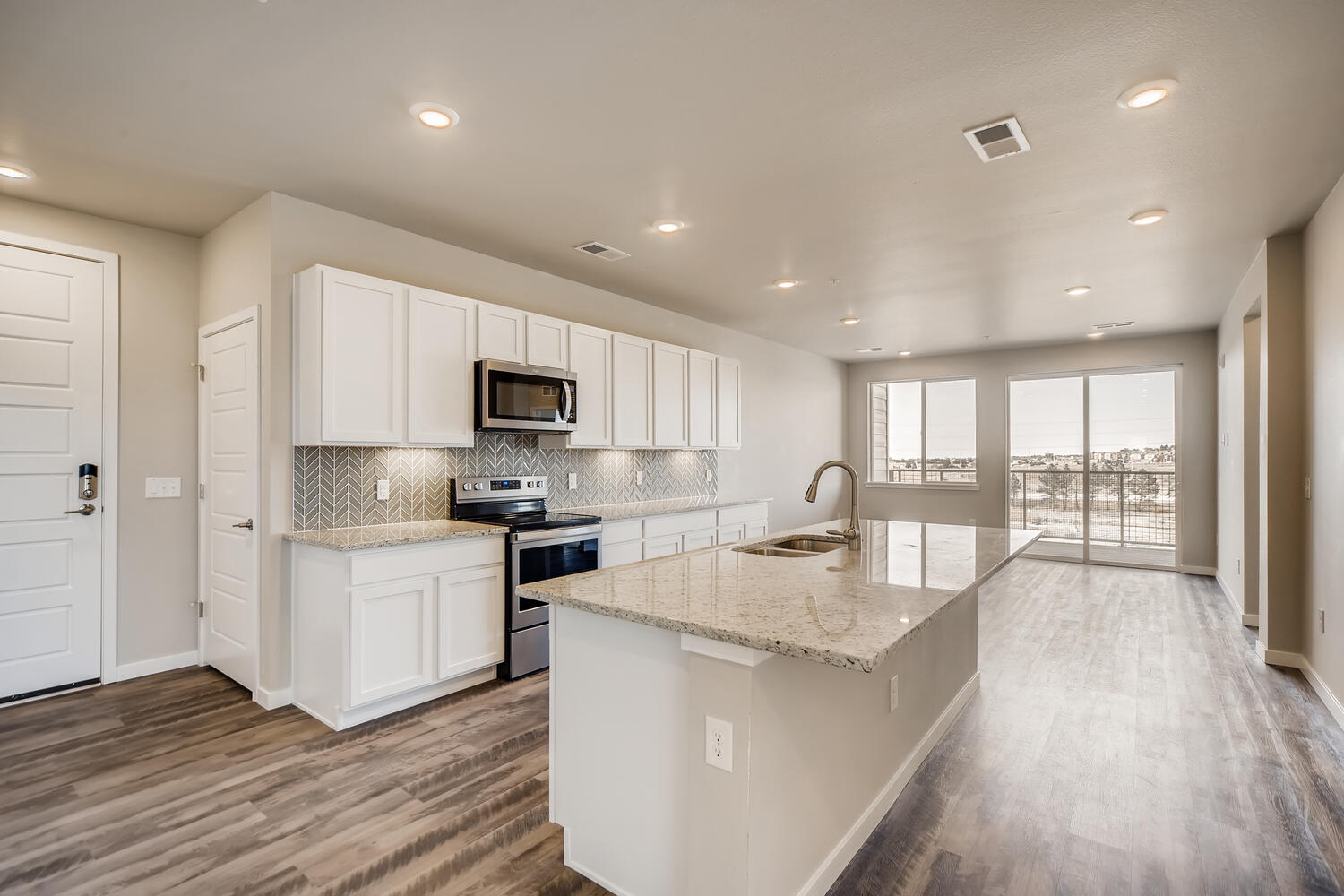 A kitchen with white cabinets.