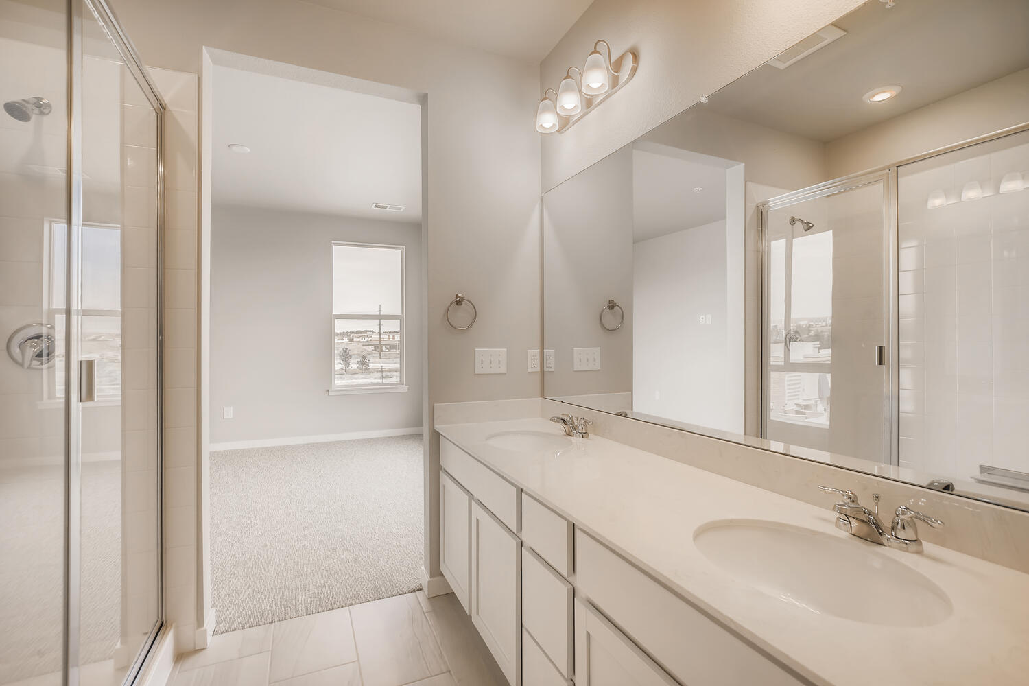 A bathroom with a sink and shower.