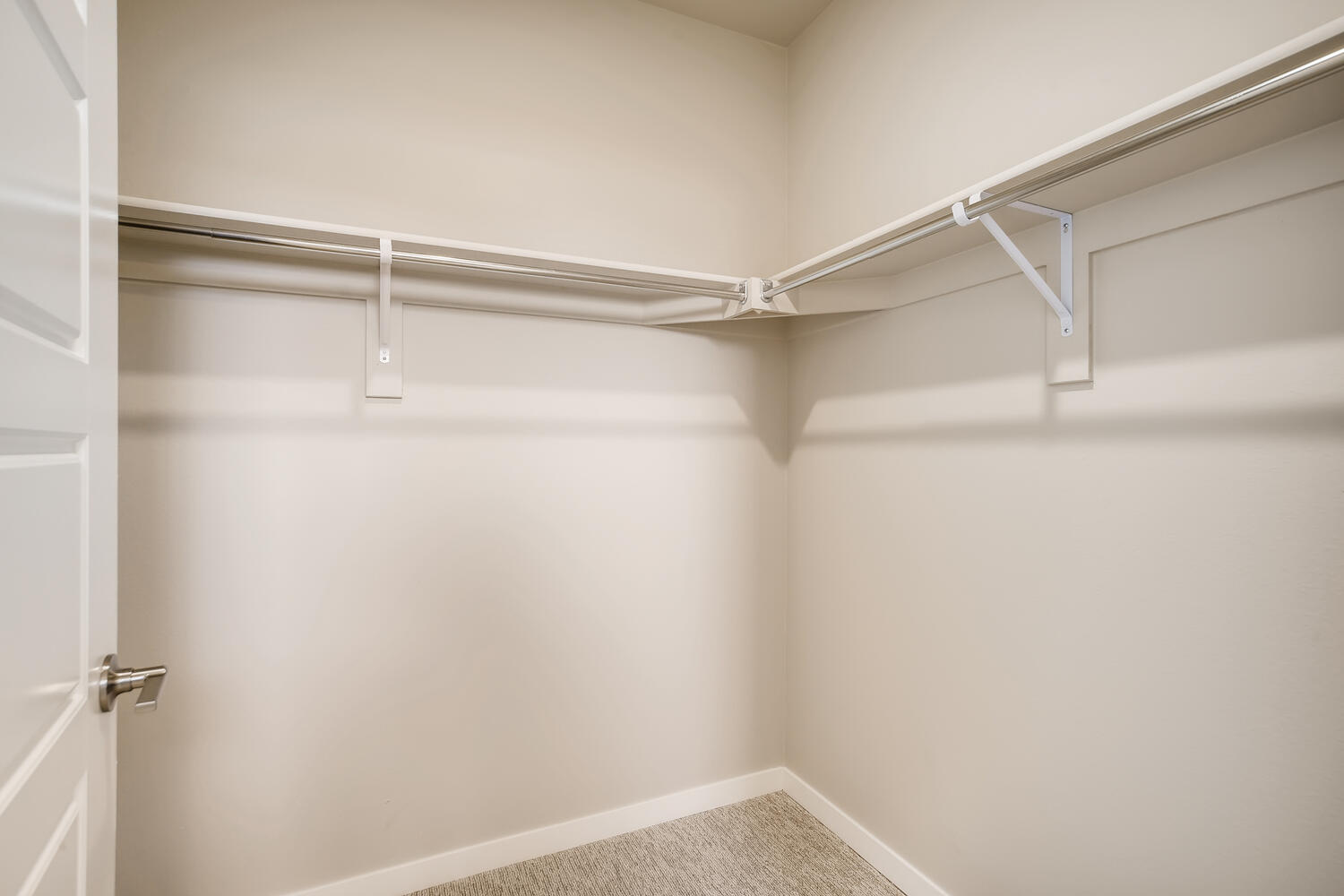 A shower with a metal bar.