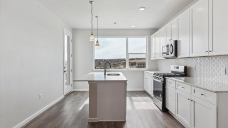 A kitchen with white cabinets.
