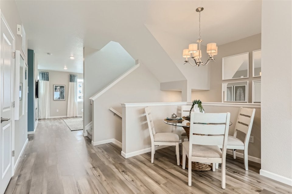 A dining room with a table and chairs.