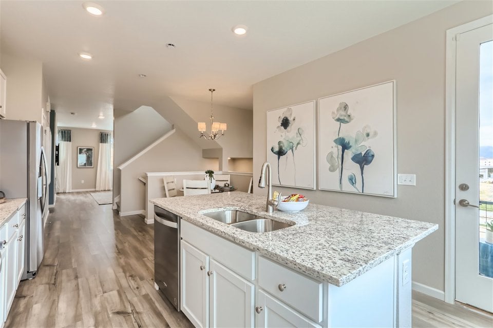 A kitchen with marble counters.