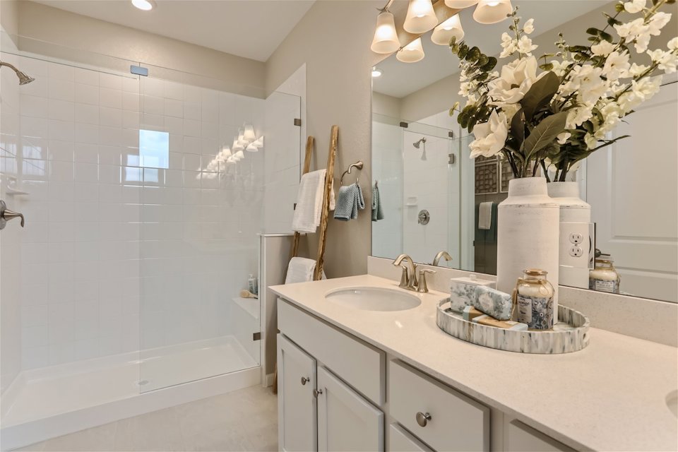 A bathroom with a large mirror.