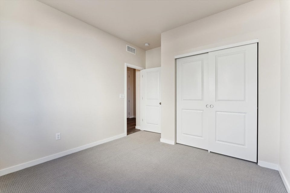 A hallway with white doors.