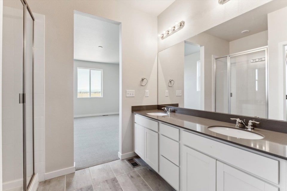 A bathroom with a large mirror.