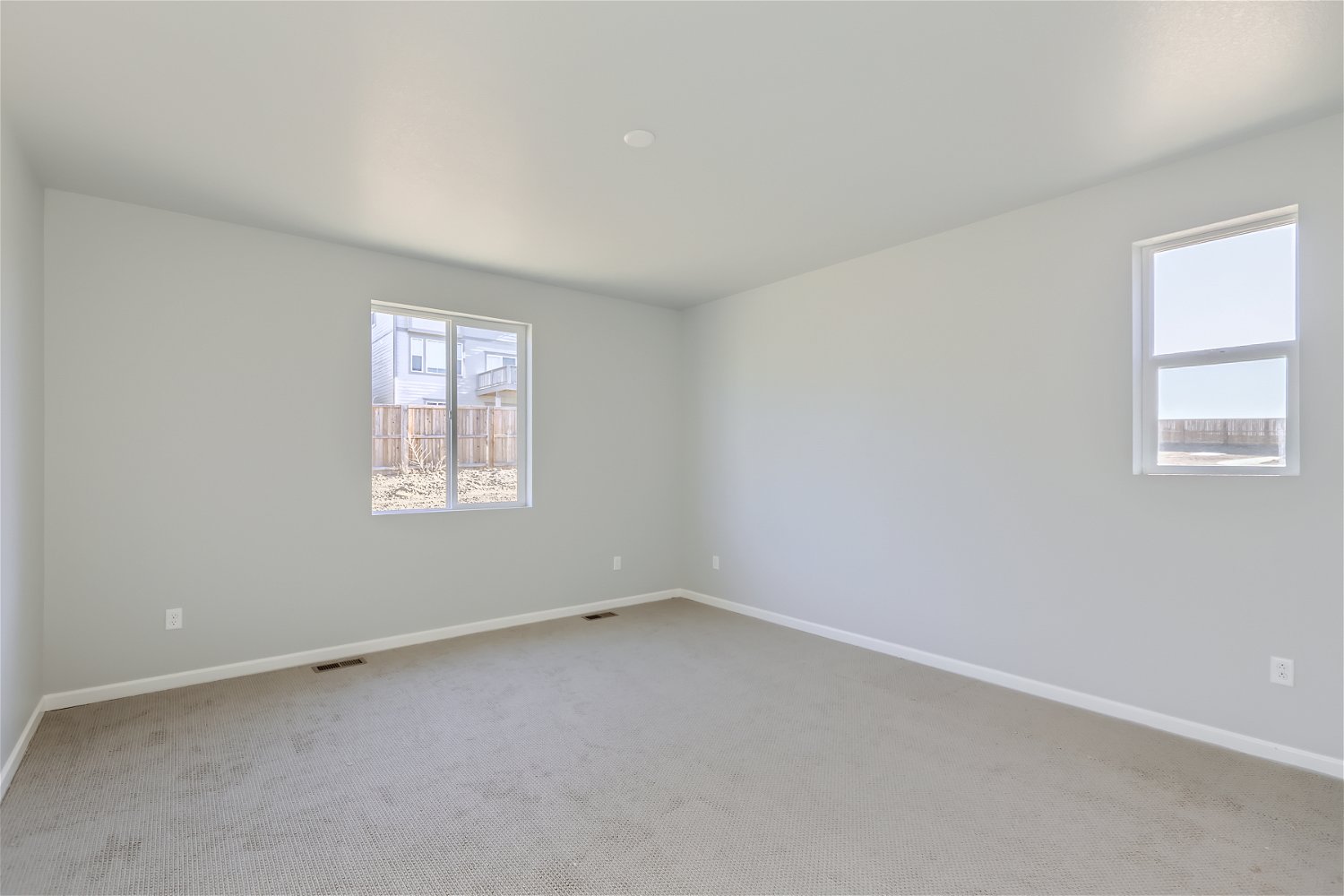 A room with a window and a carpet.