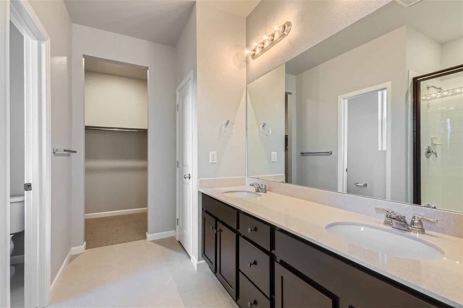 A bathroom with a large mirror.