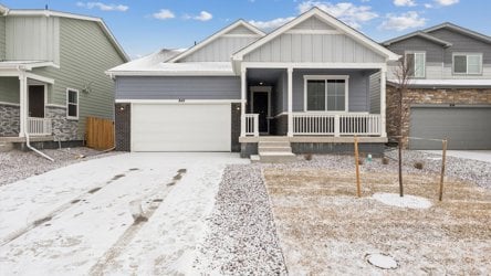 A house with a garage and a fence in the front.