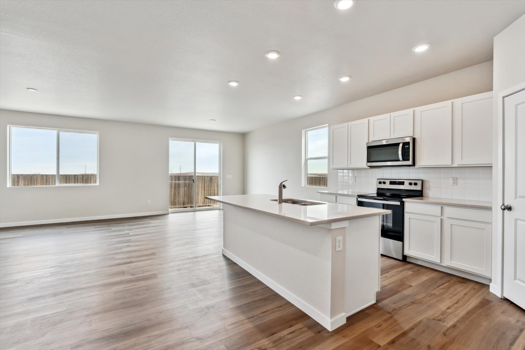 A kitchen with white cabinets.