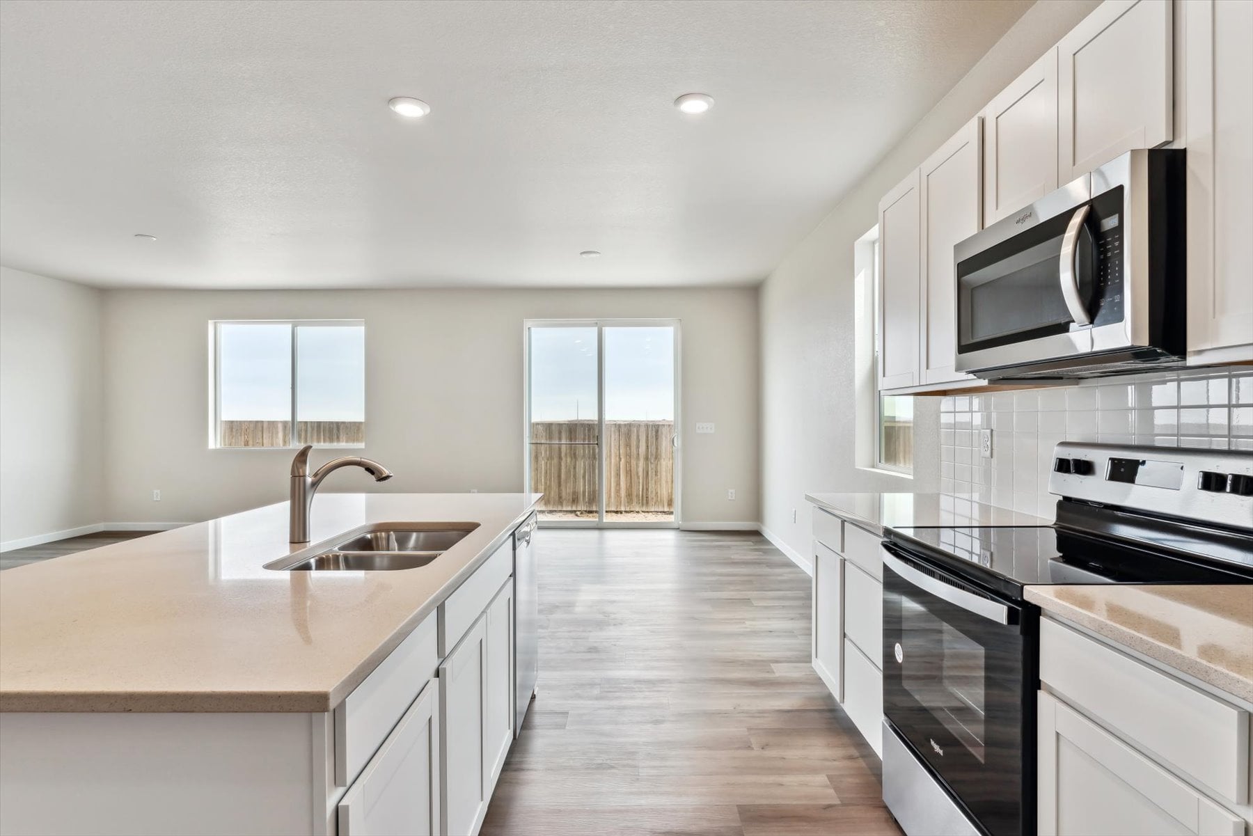A kitchen with white cabinets.