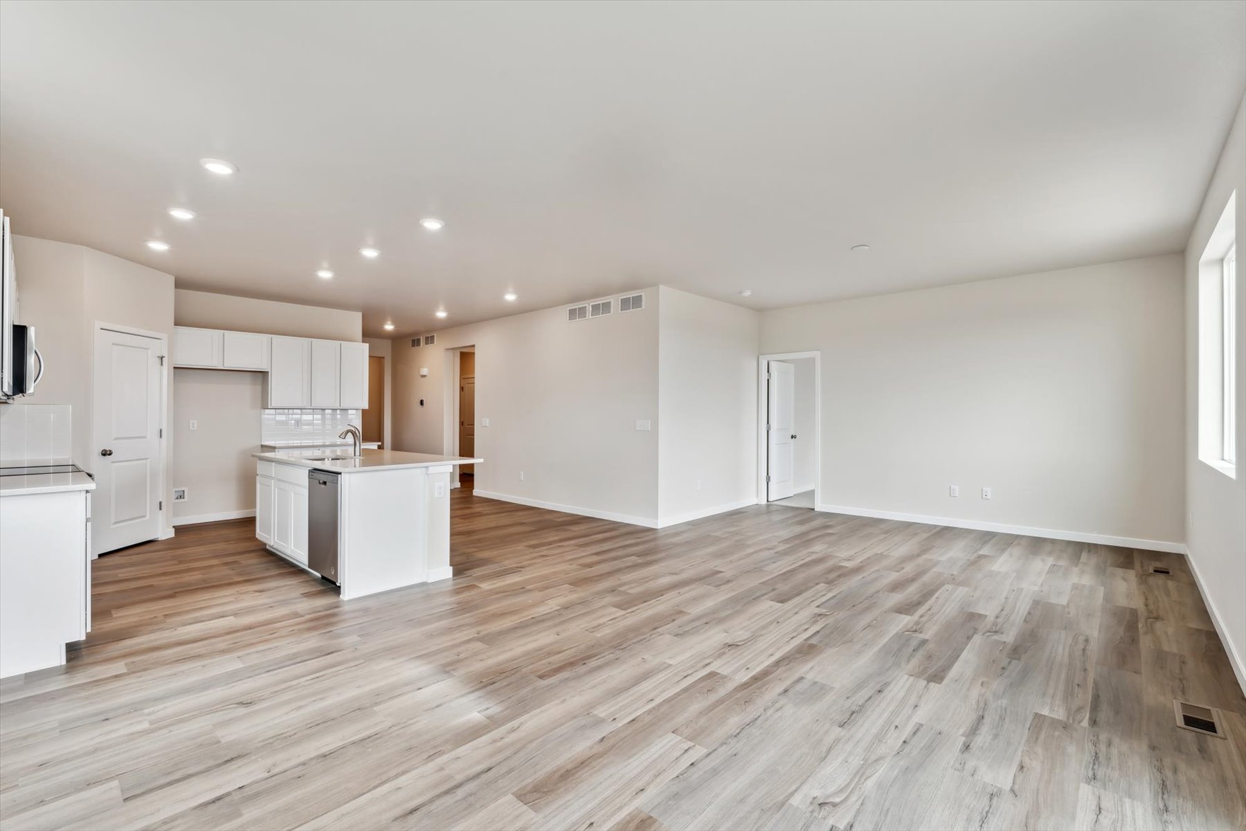 A large kitchen with white cabinets.