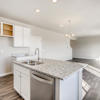 Kitchen island and great room of the Fraser floor plan by Century Communities