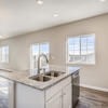 Kitchen in natural light of windows of the Fraser floor plan by Century Communities