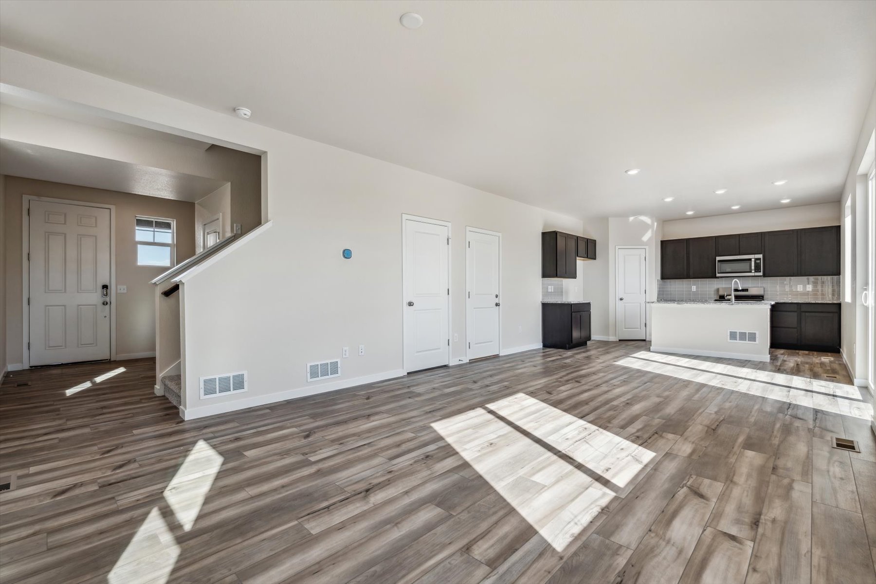 A room with a wood floor and white walls.
