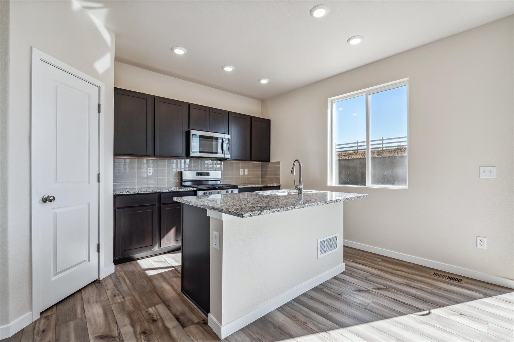 A kitchen with black cabinets.